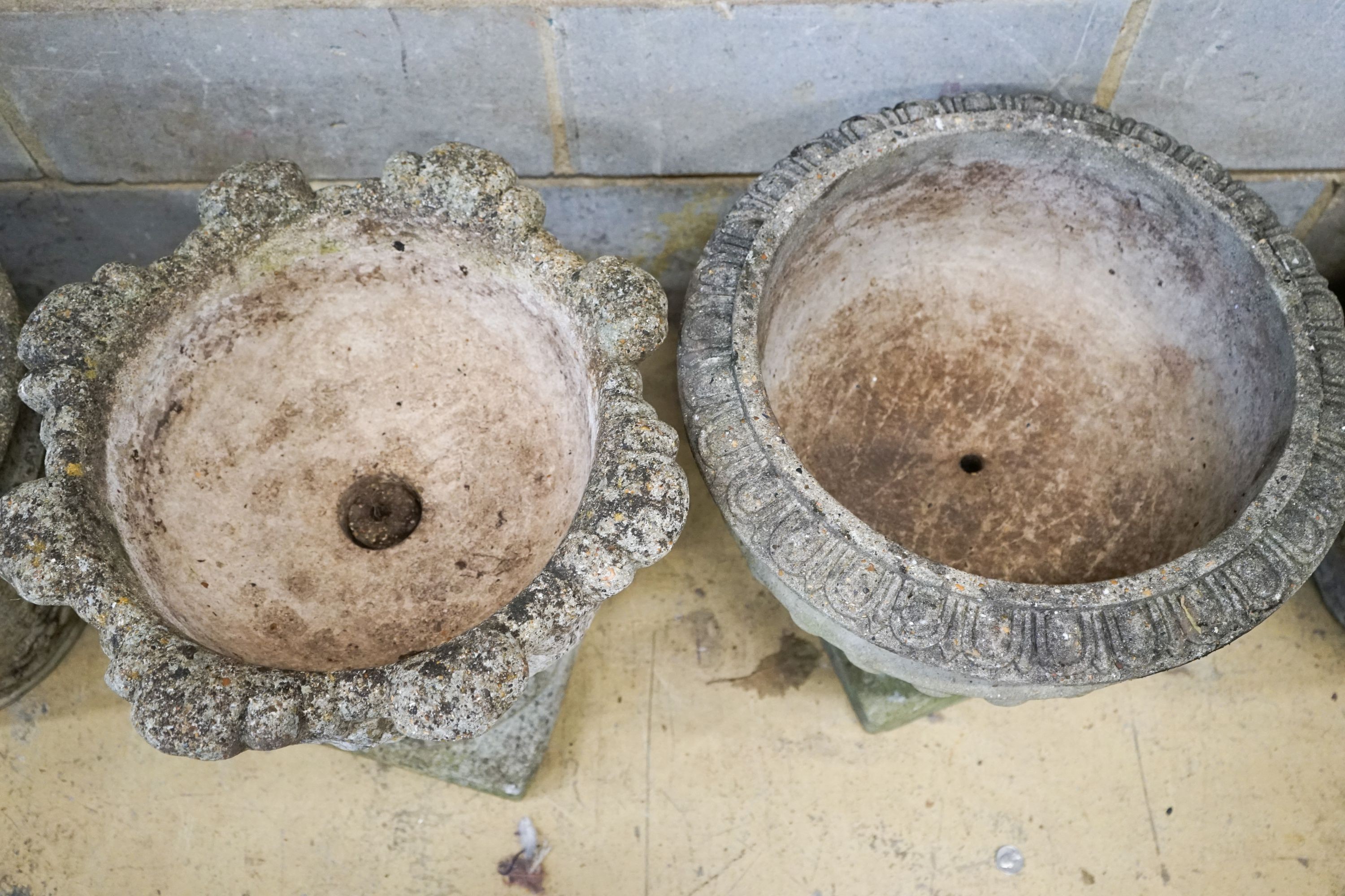 Four assorted reconstituted stone garden urns and a galvanised tub